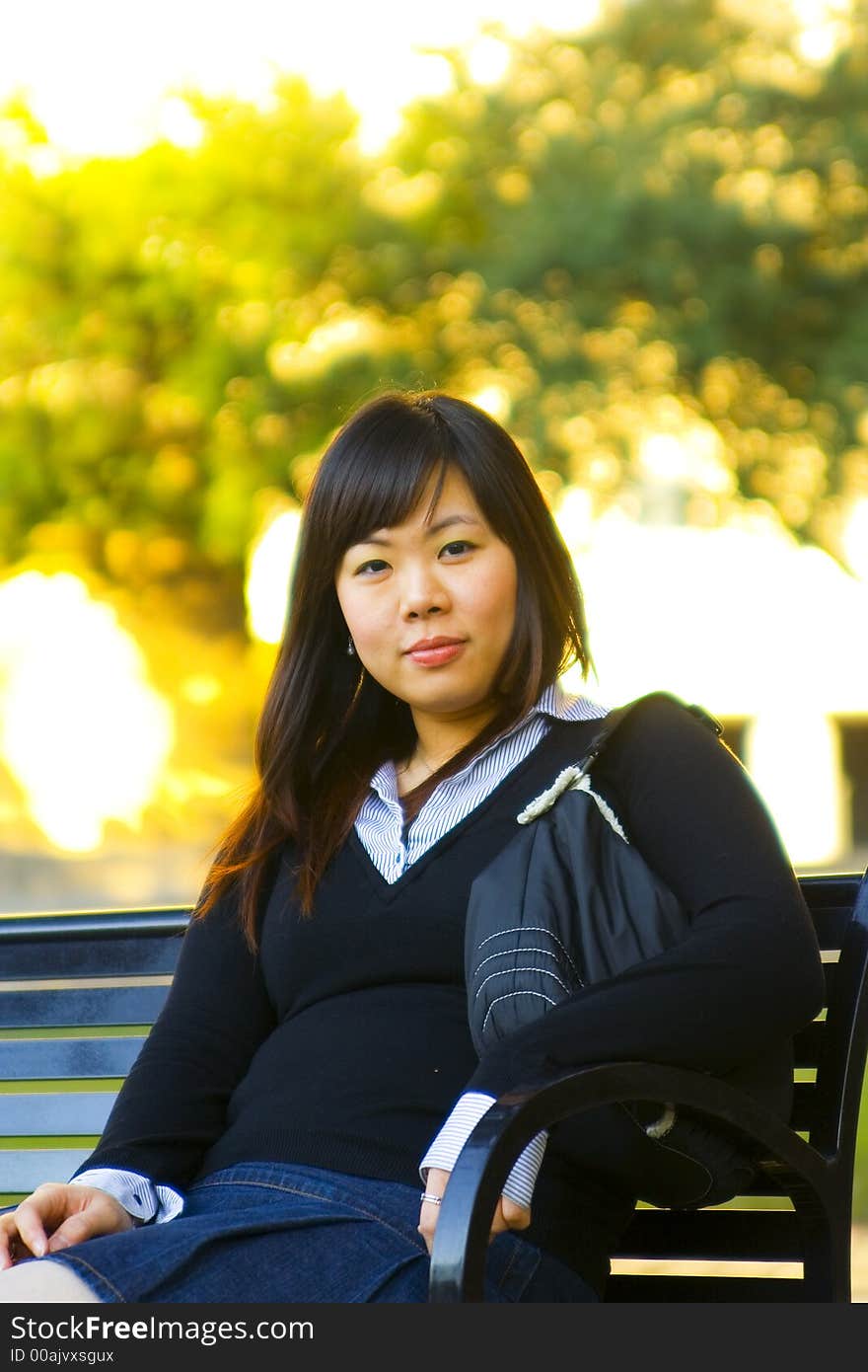 Young asian girl sit on bench