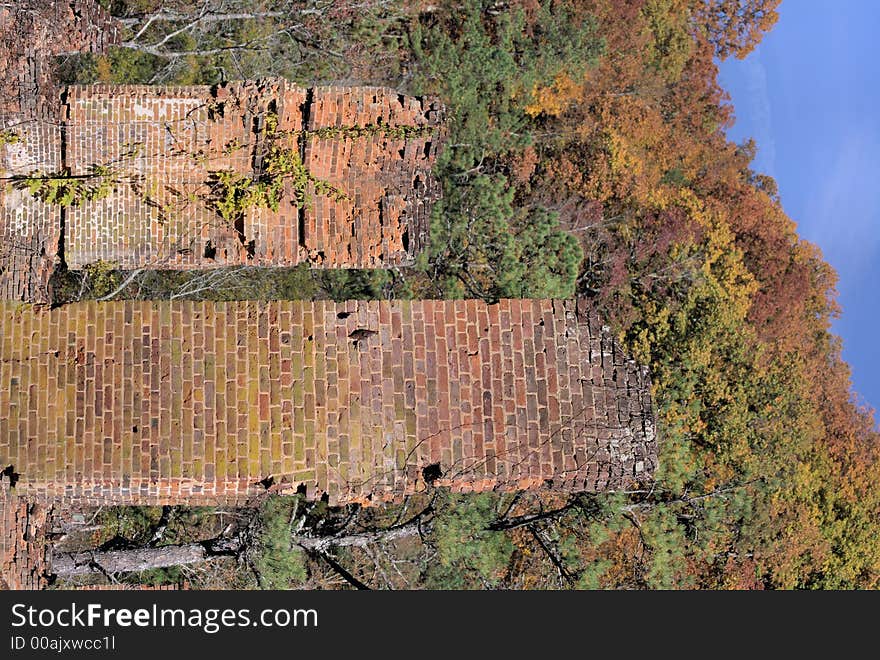 Old grist mill ruins from the civil war era with an autumn background.  If you look closely you can see buckshot holes near the bottom of the columns from a civil war battle. Old grist mill ruins from the civil war era with an autumn background.  If you look closely you can see buckshot holes near the bottom of the columns from a civil war battle.