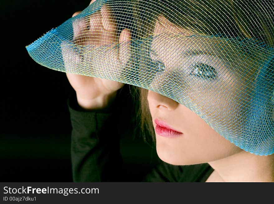 Face of woman with stylish grid as a hat. Face of woman with stylish grid as a hat