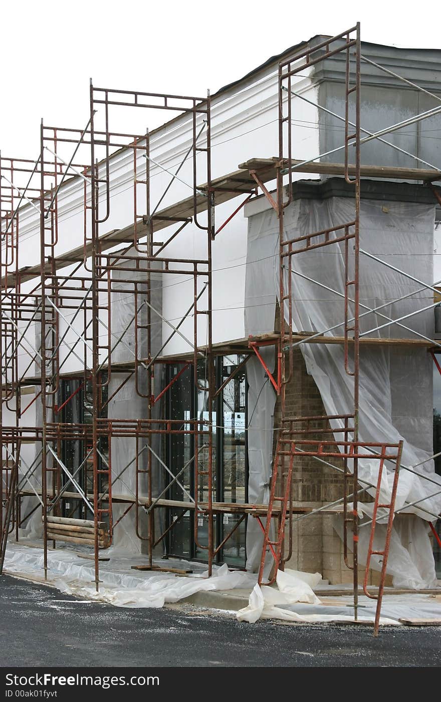 Large scaffolding surrounding a shopping center under construction.