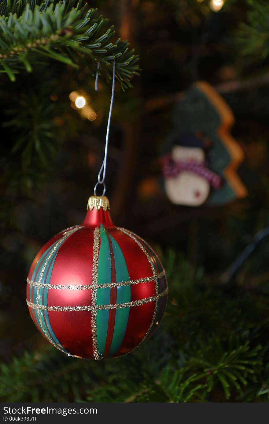 Red, green and gold christmas ornament hanging on a tree. Red, green and gold christmas ornament hanging on a tree