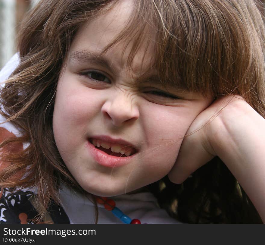 Young girl pulling a face