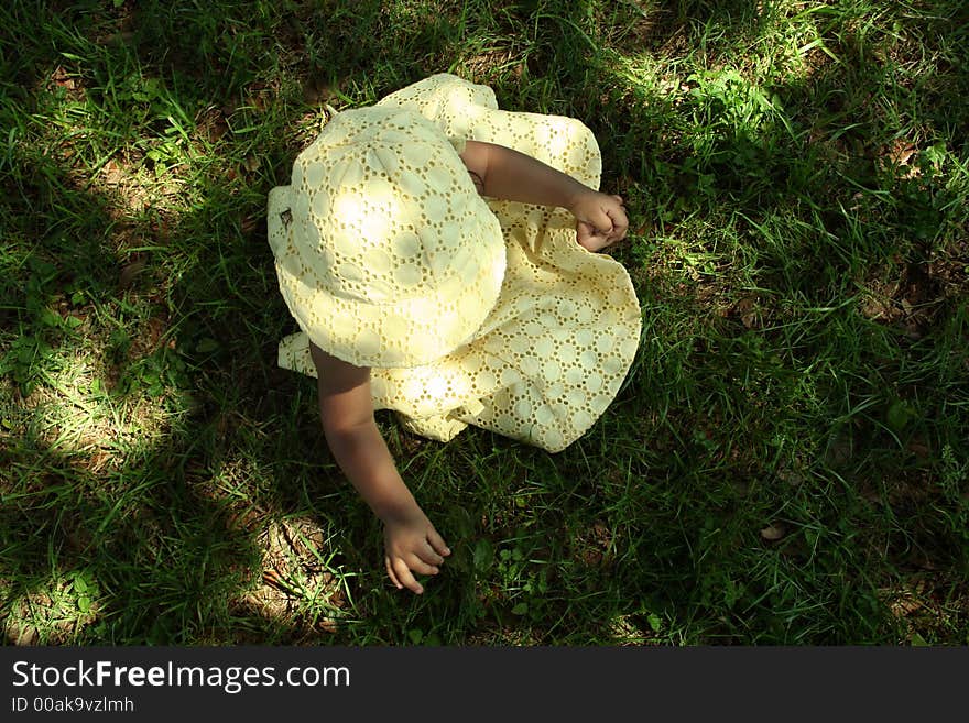 Little girl sitting in the grass. Little girl sitting in the grass.