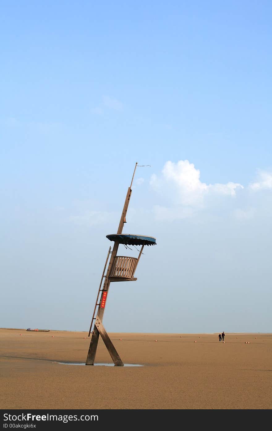 On the beach,a watchtower under blue sky