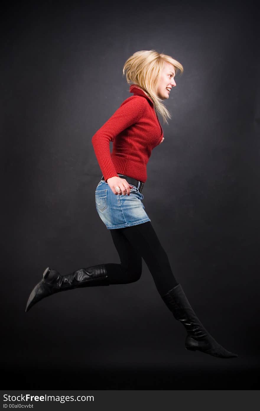 Blond girl with long legs jumping into the air. Blond girl with long legs jumping into the air