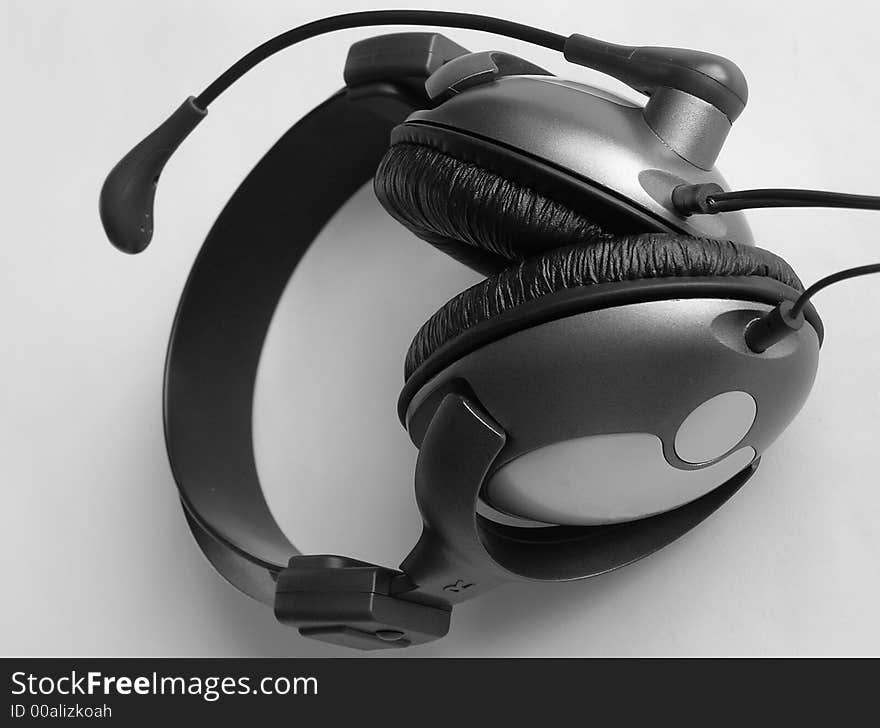 On a photo it is made in Ukraine headphones which are represented lay on a white background. A black-and-white photo. On a photo it is made in Ukraine headphones which are represented lay on a white background. A black-and-white photo