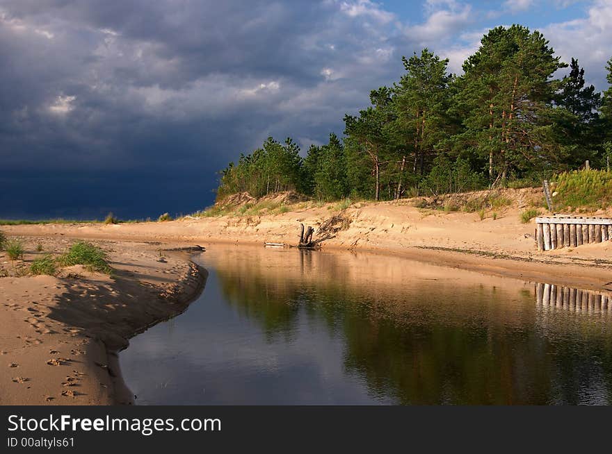 Seacoast, sun and dark clouds, river, forest