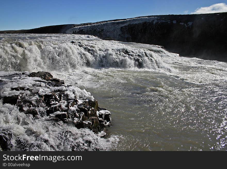 Gullfoss is a waterfall located on the White River (Hvítá) in south central Iceland. Gullfoss is also by far Europe’s most powerful waterfall. Gullfoss is an example of a waterfall forming where the water has followed a fissure in thelava and carved a passageway through it. Gullfoss is a waterfall located on the White River (Hvítá) in south central Iceland. Gullfoss is also by far Europe’s most powerful waterfall. Gullfoss is an example of a waterfall forming where the water has followed a fissure in thelava and carved a passageway through it