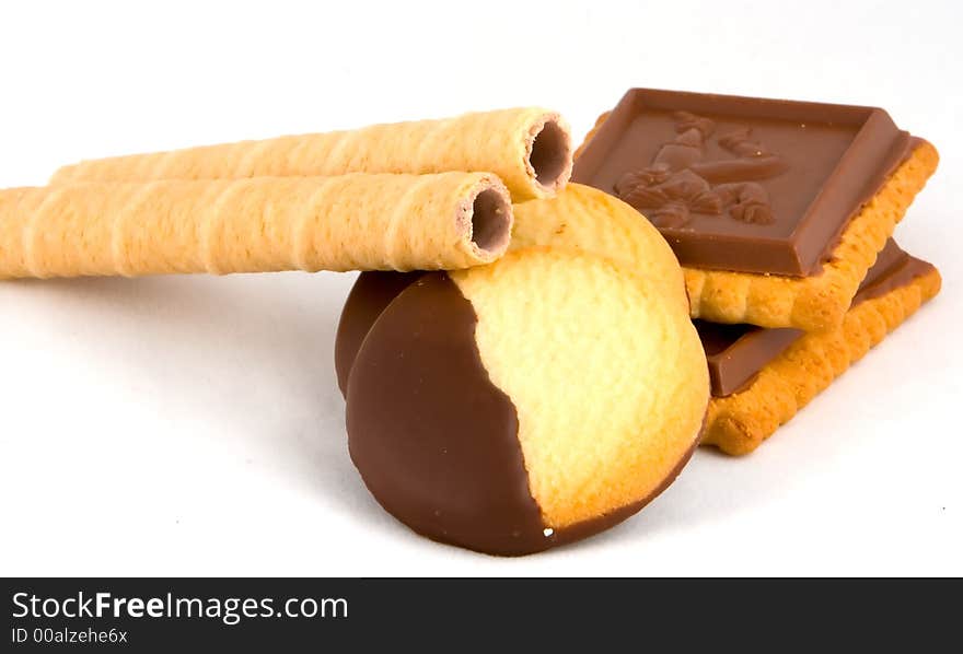 Several chocolate covered cookies on white background