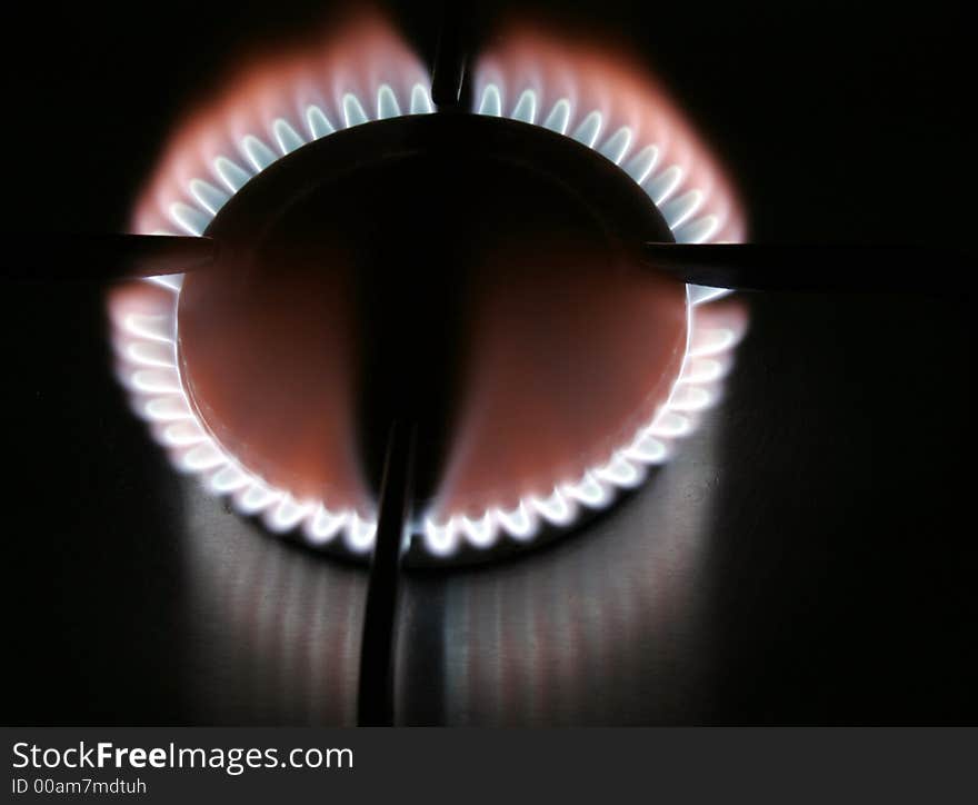 Blue Flame Of A Stove Burner In Darkness Illustrating Combustion Of Gas. Blue Flame Of A Stove Burner In Darkness Illustrating Combustion Of Gas