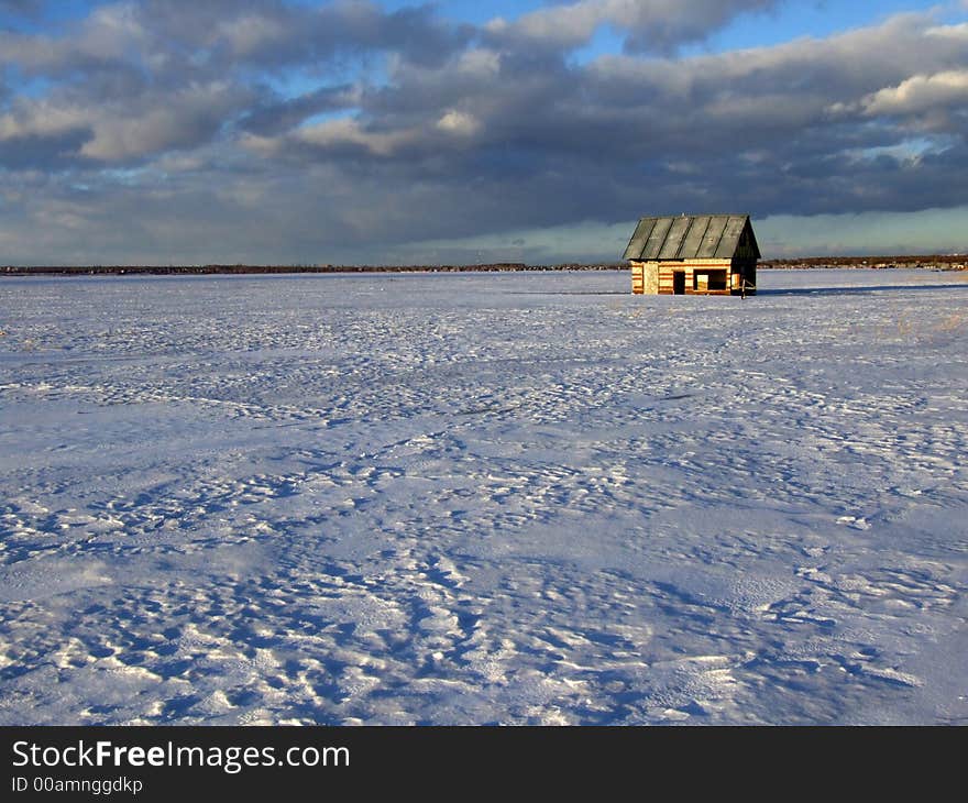 Winter lake with the flooded house on a background of the sky. Winter lake with the flooded house on a background of the sky.