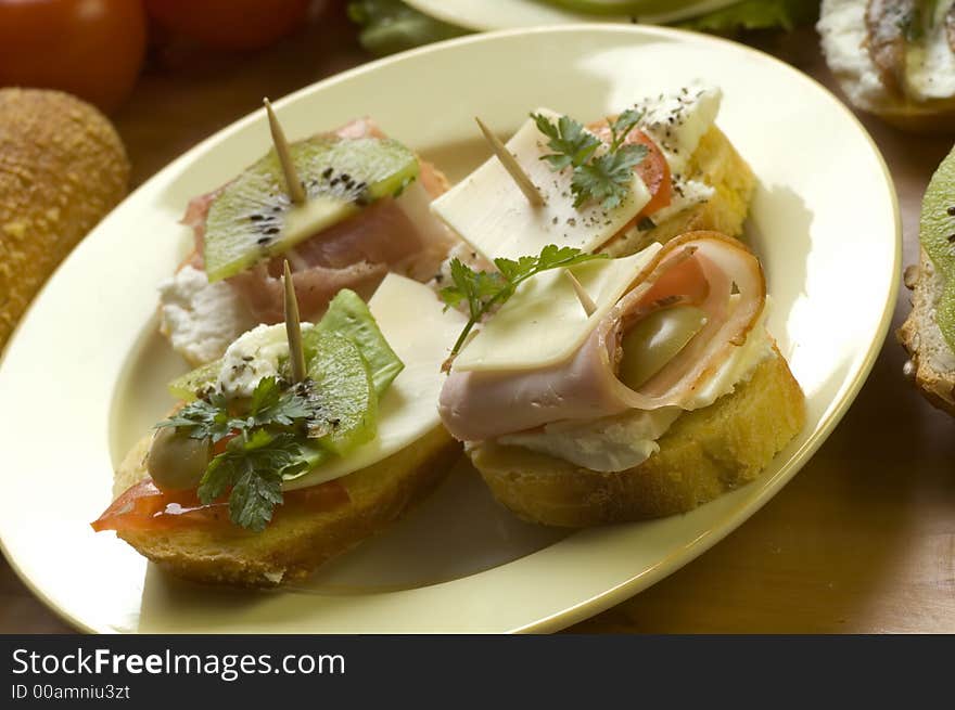 Arranged snack made of small sandwiches close up. Arranged snack made of small sandwiches close up