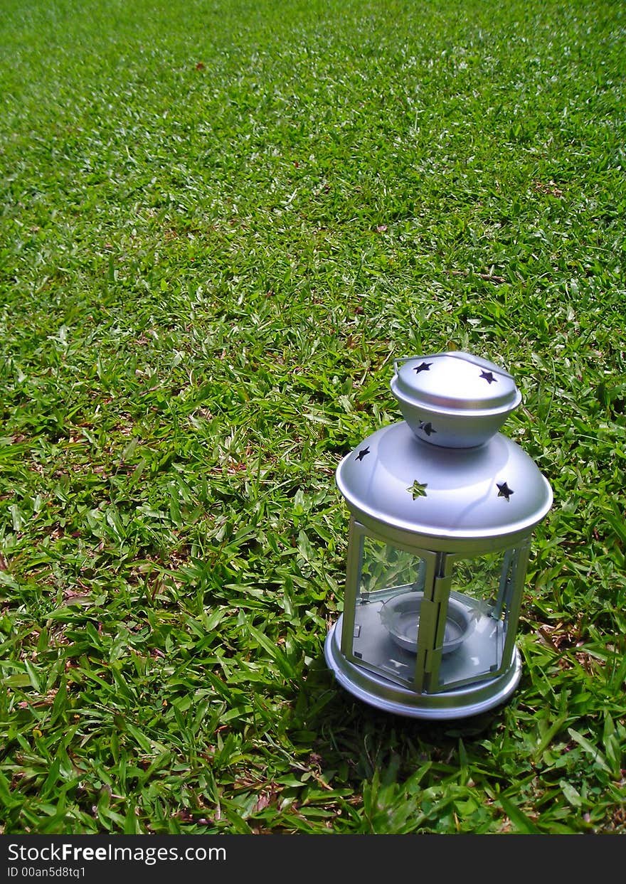 Silver Christmas Lamp On Green Grass Background