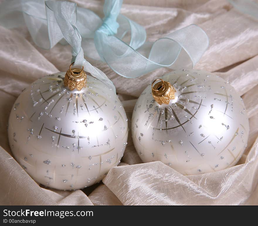 Two christmas spheres on a pink fabric. Two christmas spheres on a pink fabric