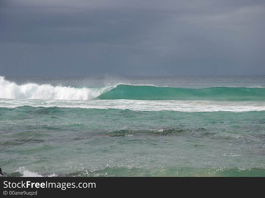 Turquoise wave breaking