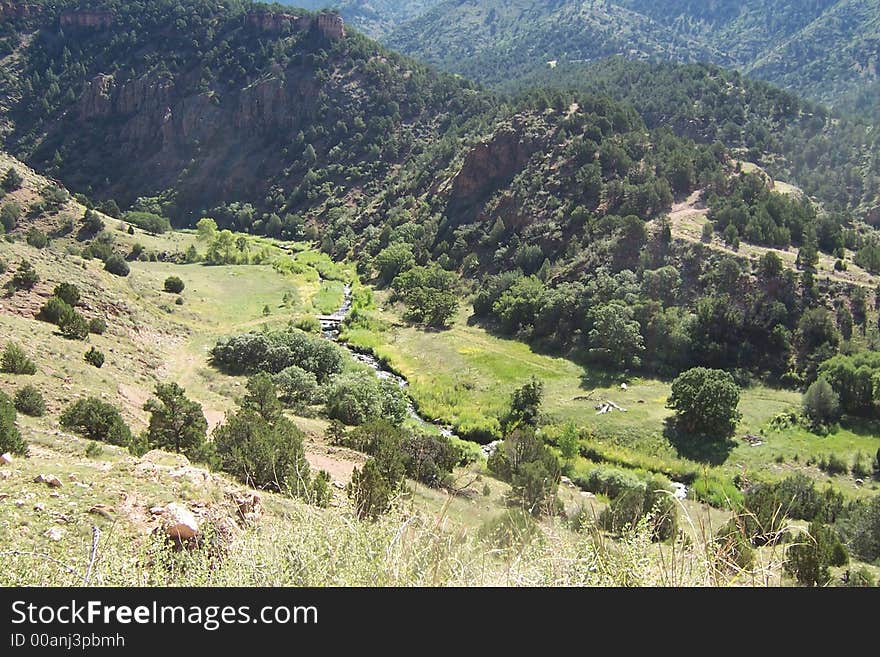 A view from high colorado mountains. The road joins Cañon City and Victor in central Colorado, USA. Summer grass and trees. A view from high colorado mountains. The road joins Cañon City and Victor in central Colorado, USA. Summer grass and trees