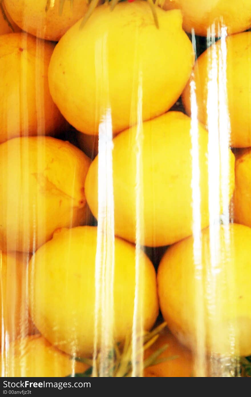 Fresh lemons in a glass container