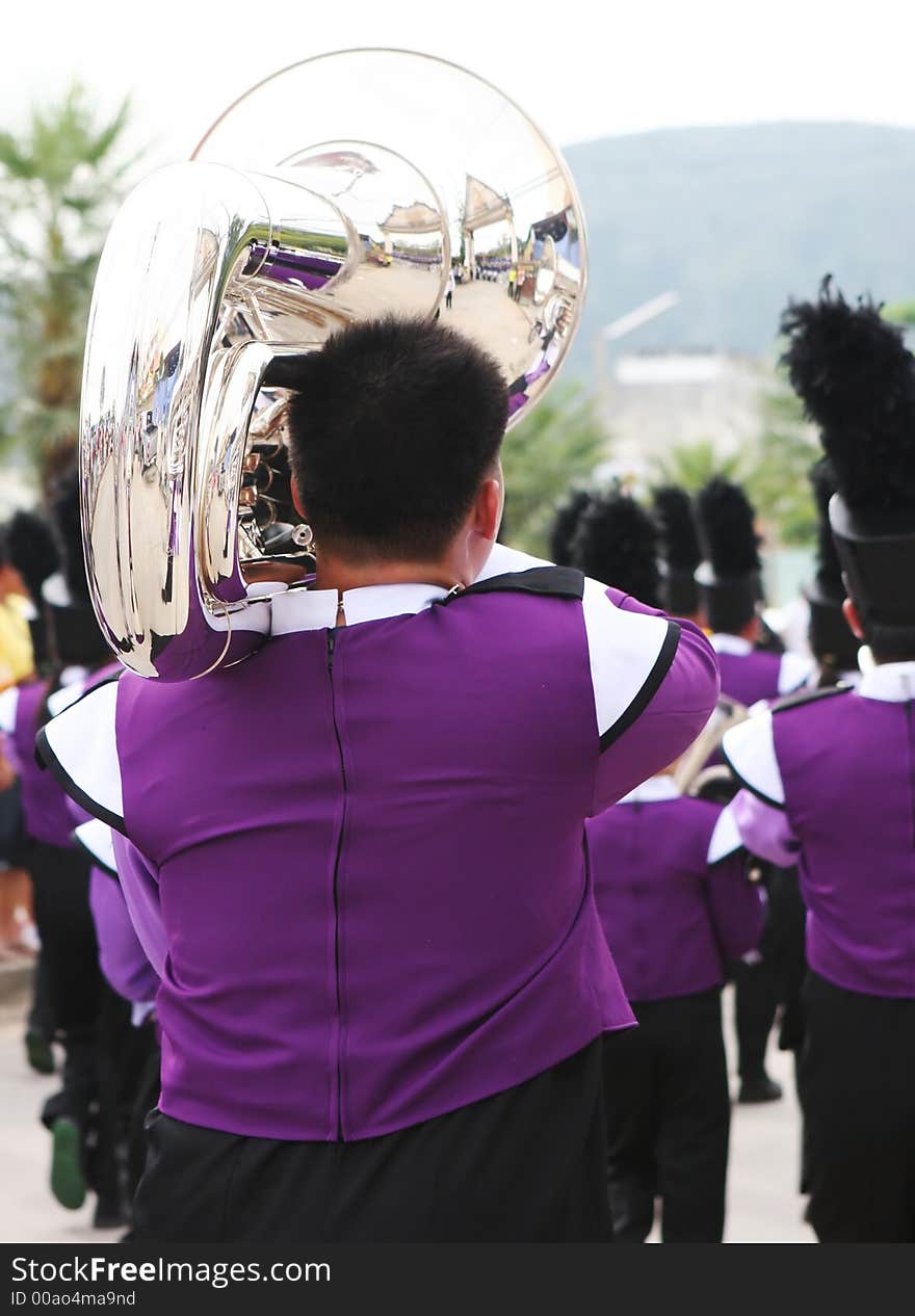 Marching band member playing the trombone