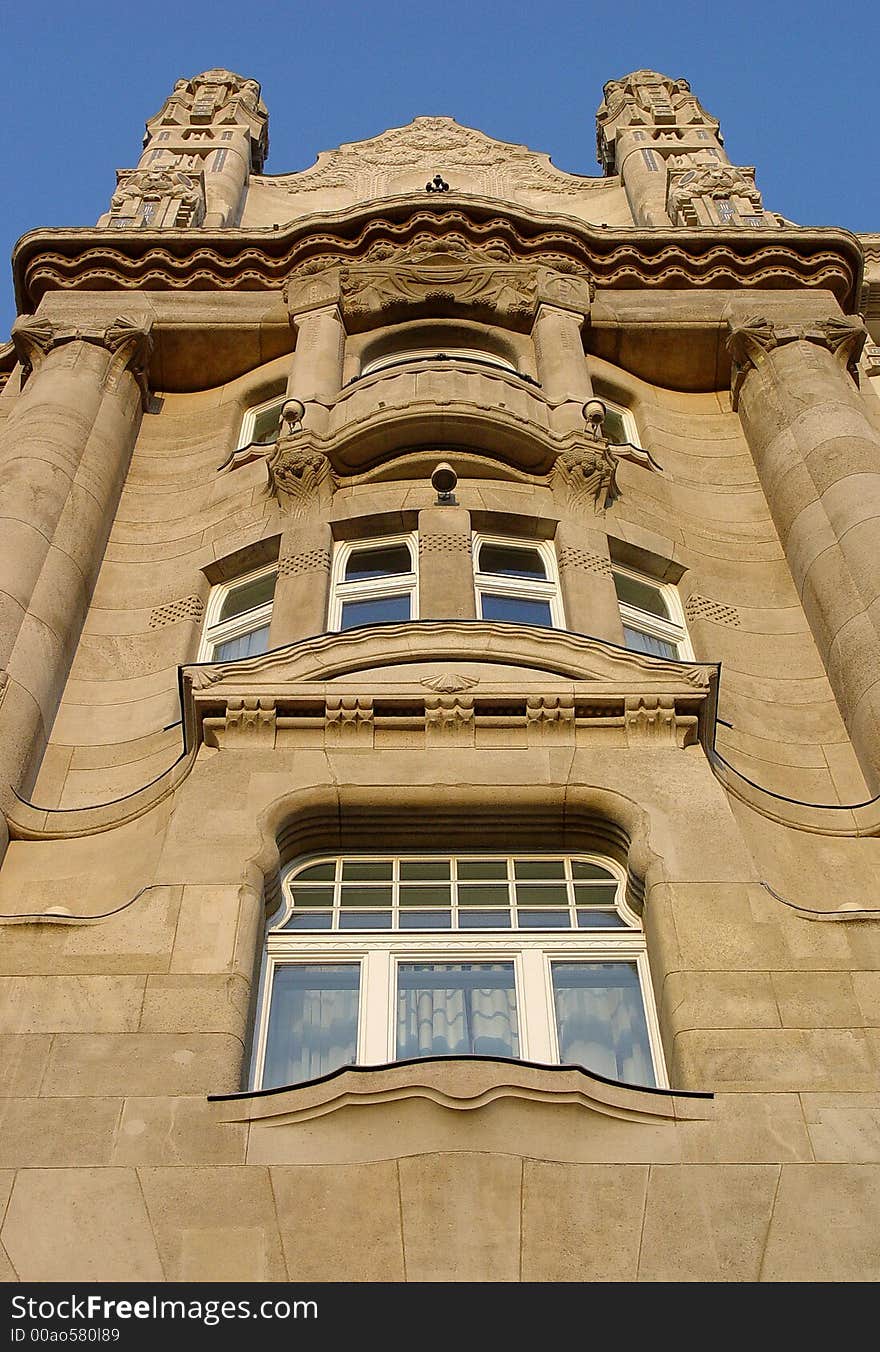 The facade of a tower on the Gresham Palace in Budapest at sunset