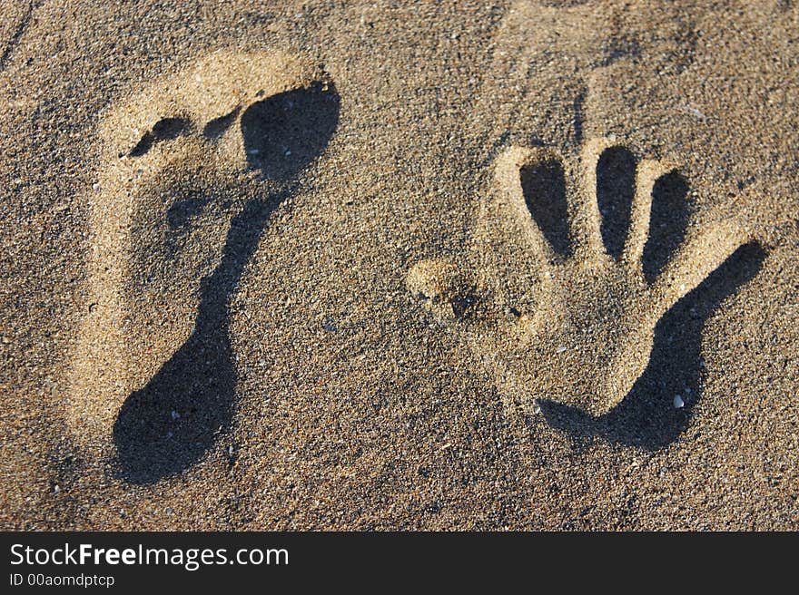 Stamps in the sand in sunlight