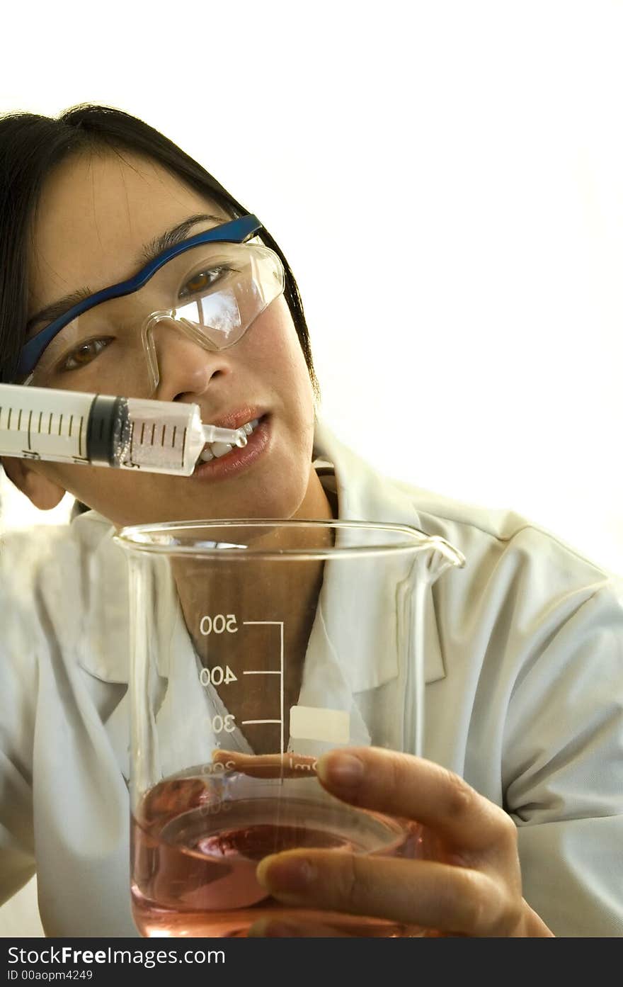 Female worker/scientist examining product on white background