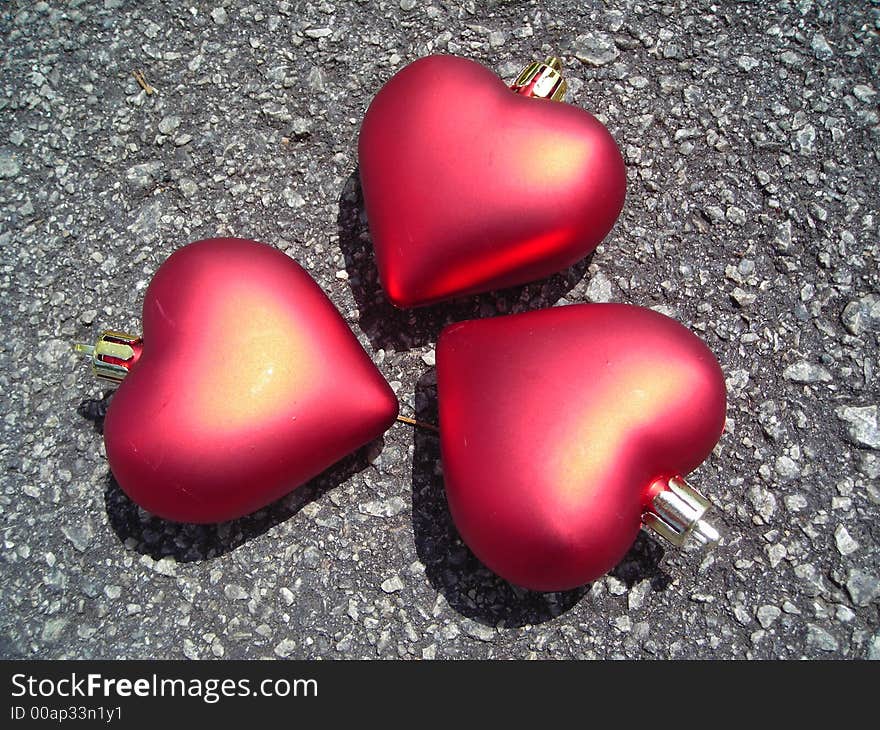 Closeup of three hearts made of christmas decoration symbolising friendship