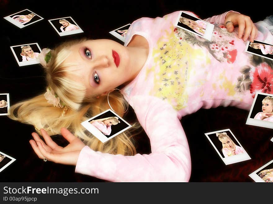 Beautiful German teen girl surrounded by polaroids.