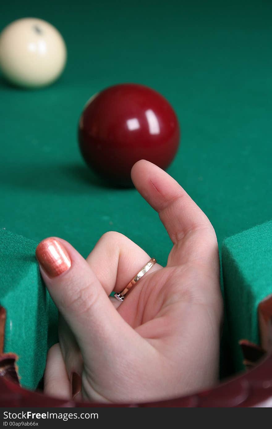 Two balls on the billiards table and hand. Two balls on the billiards table and hand