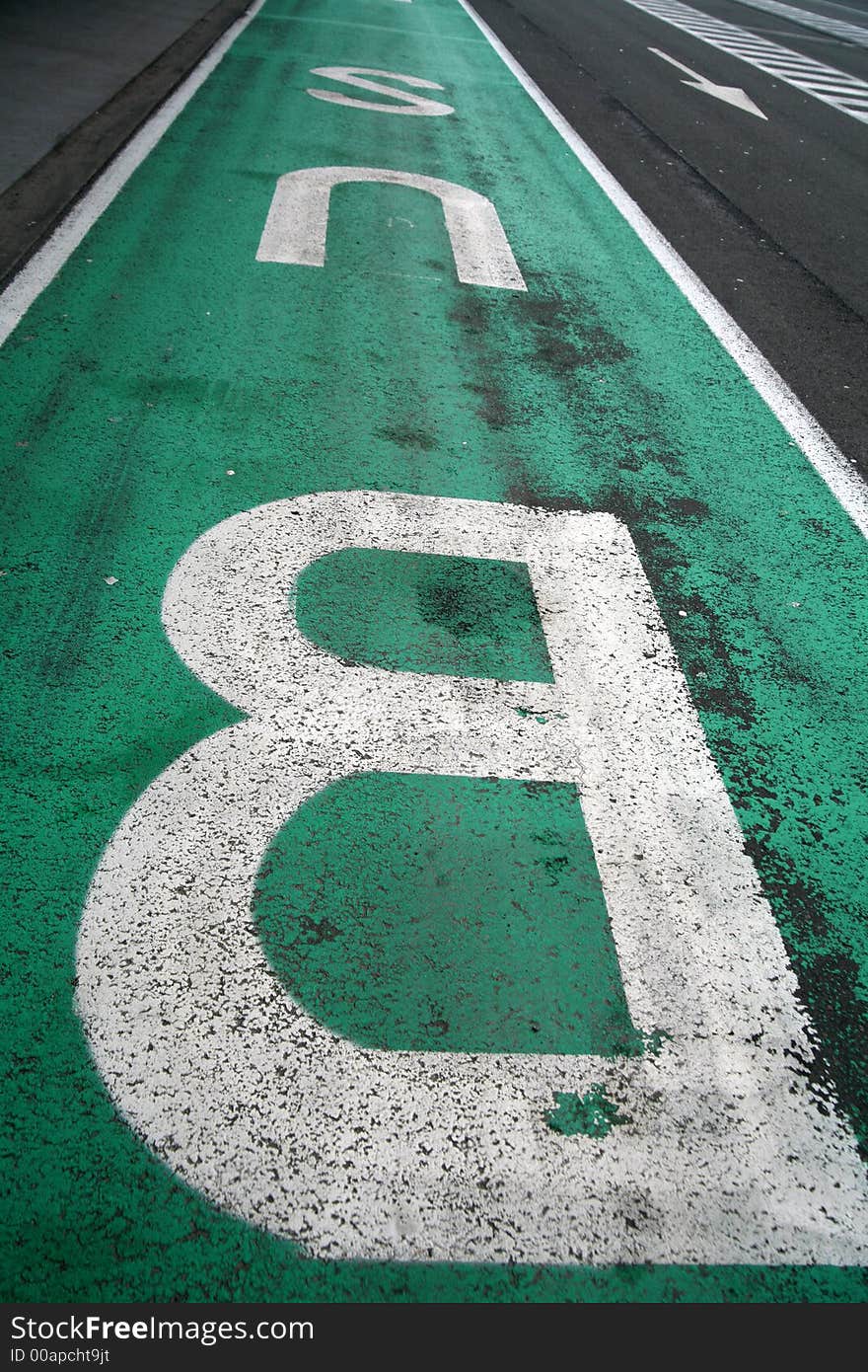 Green / white bus sign on the road