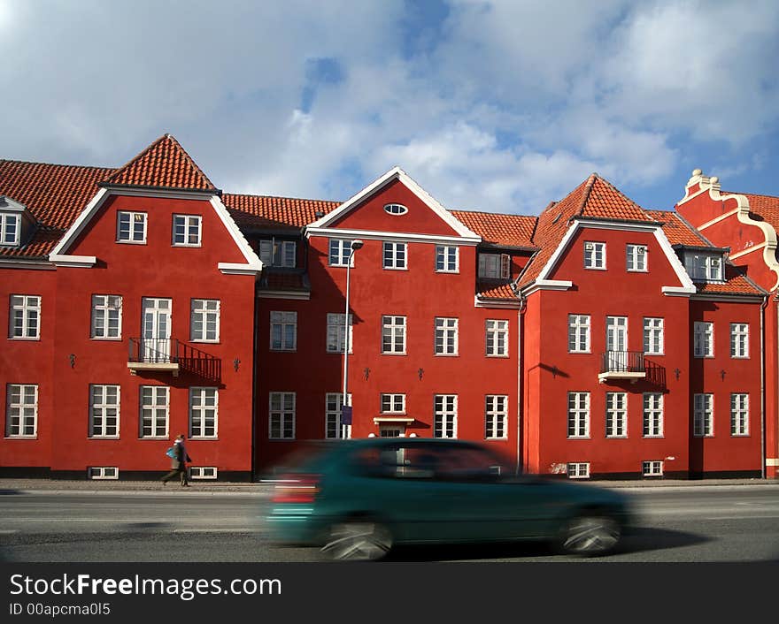 Traffic , cars   speeding in front of an old red building / house (low shutter speed). Traffic , cars   speeding in front of an old red building / house (low shutter speed)