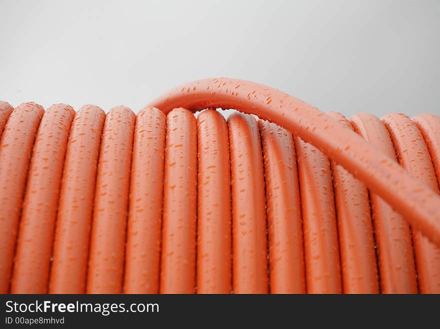 Water drops on a red pipe surface. Water drops on a red pipe surface