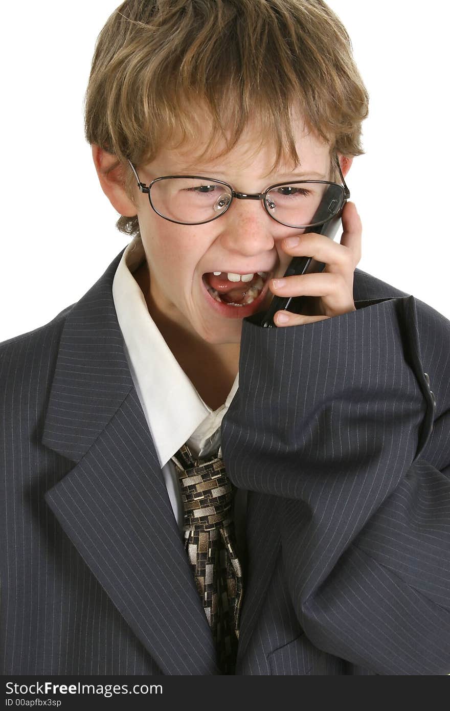 Adorable eight year old boy in father's business suit yelling into cellphone. Adorable eight year old boy in father's business suit yelling into cellphone.