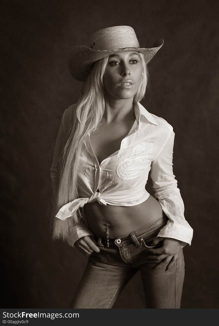 Portrait of the beautiful blonde in hat. b/w+sepia