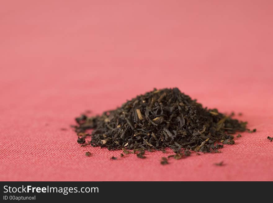 Mound of loose Earl Gray tea on red cloth. Mound of loose Earl Gray tea on red cloth