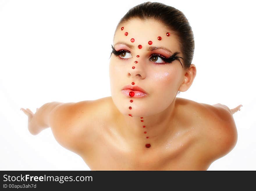 Beautiful young woman in artistic make-up, beads and feathers. Arms out behind her as if to fly. Beautiful young woman in artistic make-up, beads and feathers. Arms out behind her as if to fly.