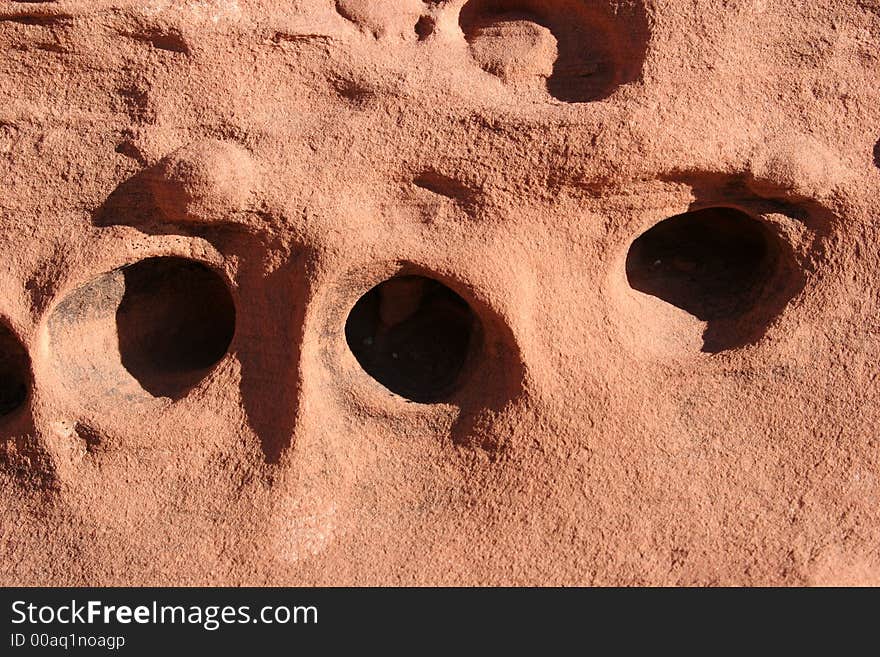 Red rock with holes textured background. Red rock with holes textured background