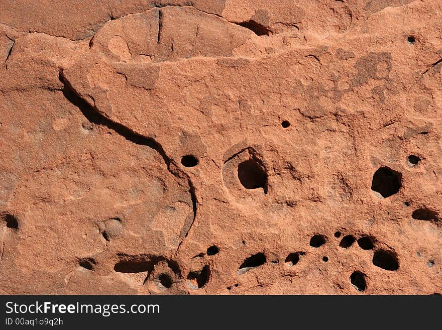 Red rock with holes textured background. Red rock with holes textured background