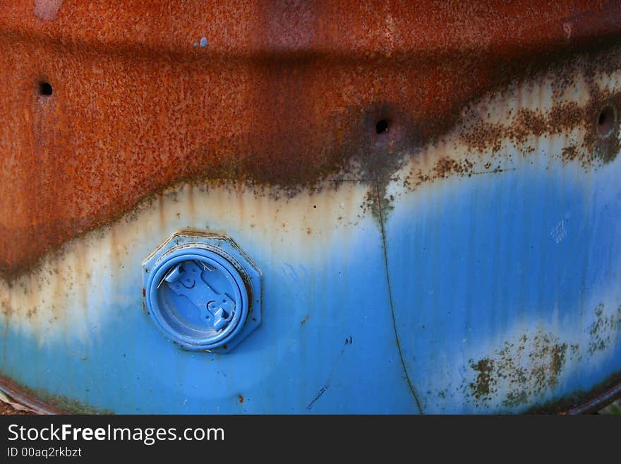 Rusty oil barrel with paint left on cap