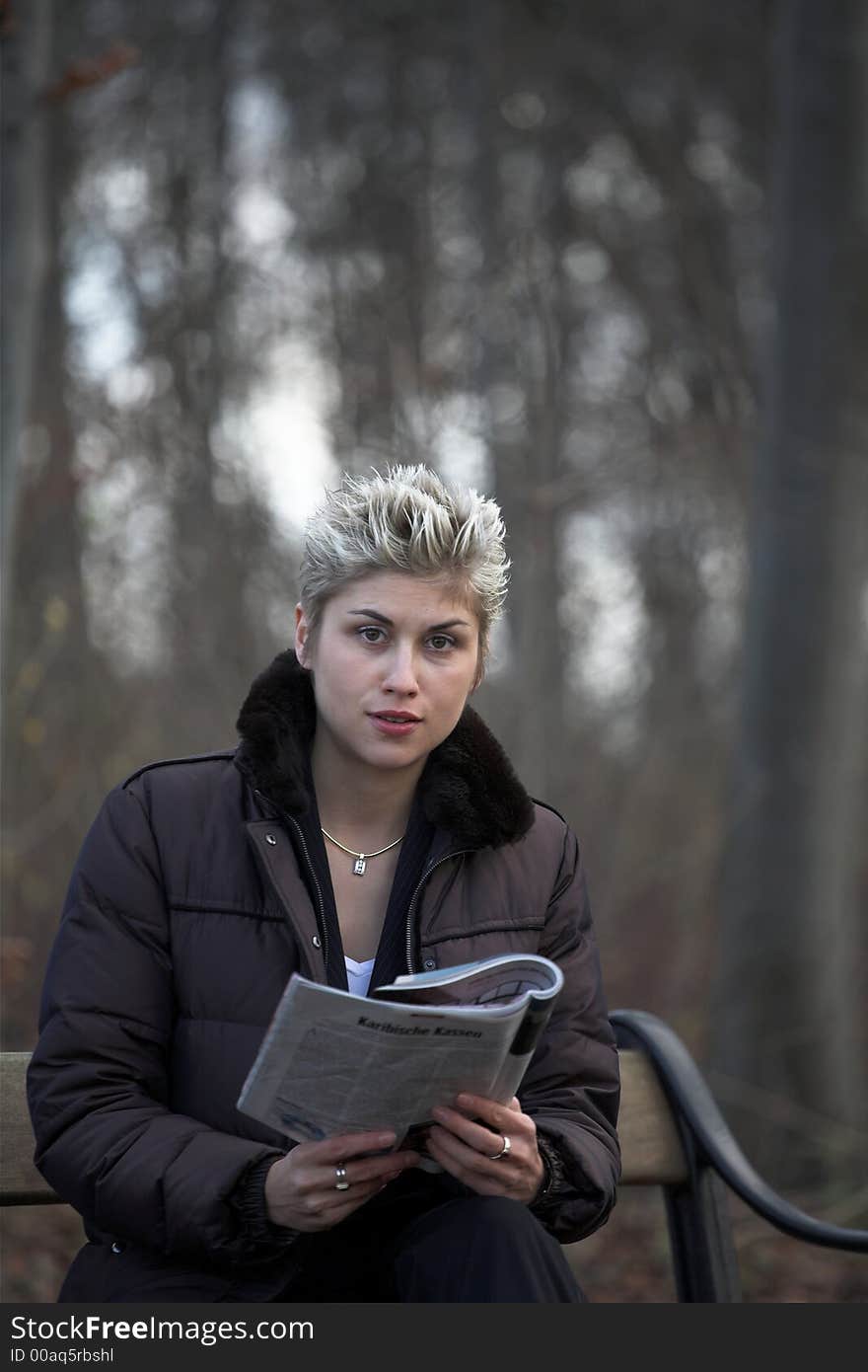 Business woman outdooring a park reading a magasine. Business woman outdooring a park reading a magasine