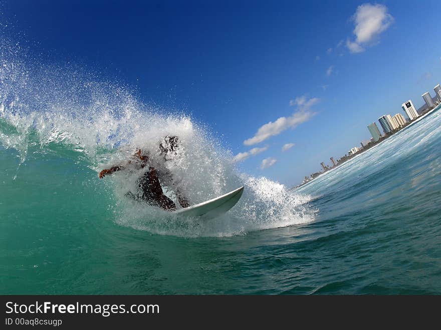 A surfer busting out of a barrel. A surfer busting out of a barrel