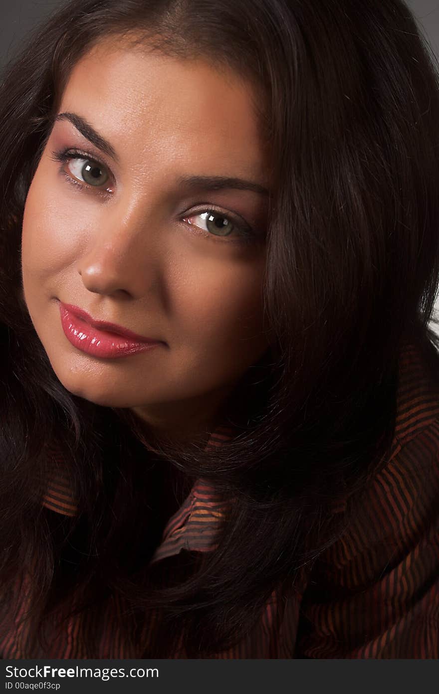 Closeup portrait of friendly brunette