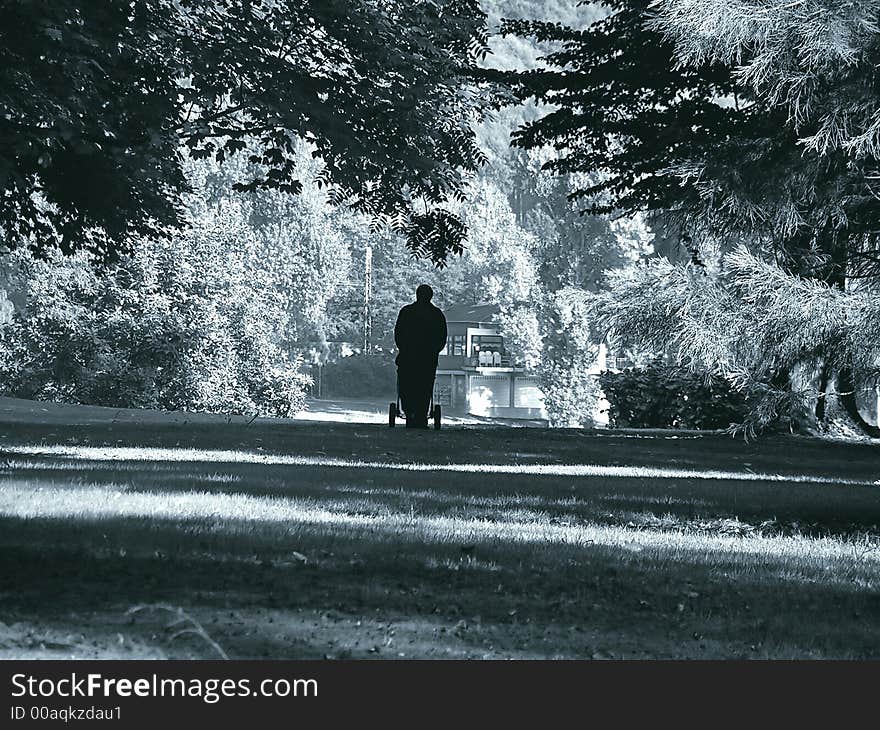 Shape of a man with a buggy walking home. Shape of a man with a buggy walking home