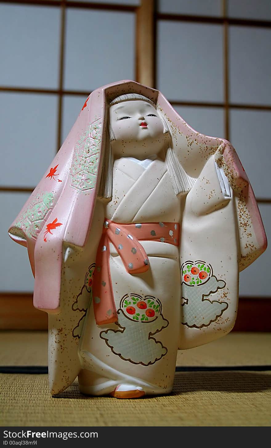 Traditional Japanese Statuette on the Mat. Traditional Japanese Statuette on the Mat