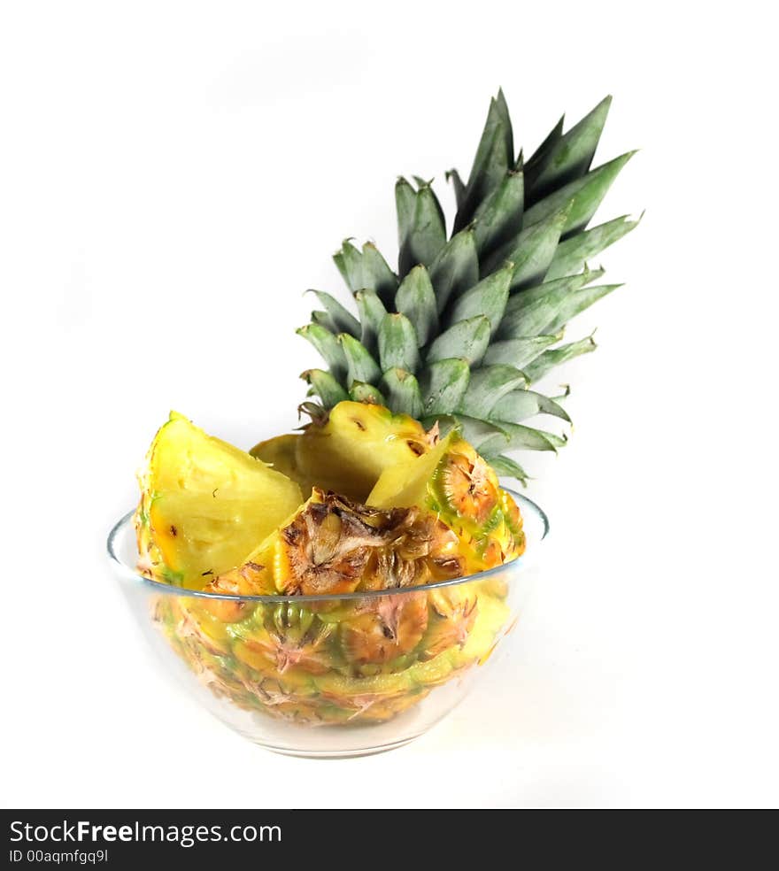 Pieces of pineapple in the glass on the white background