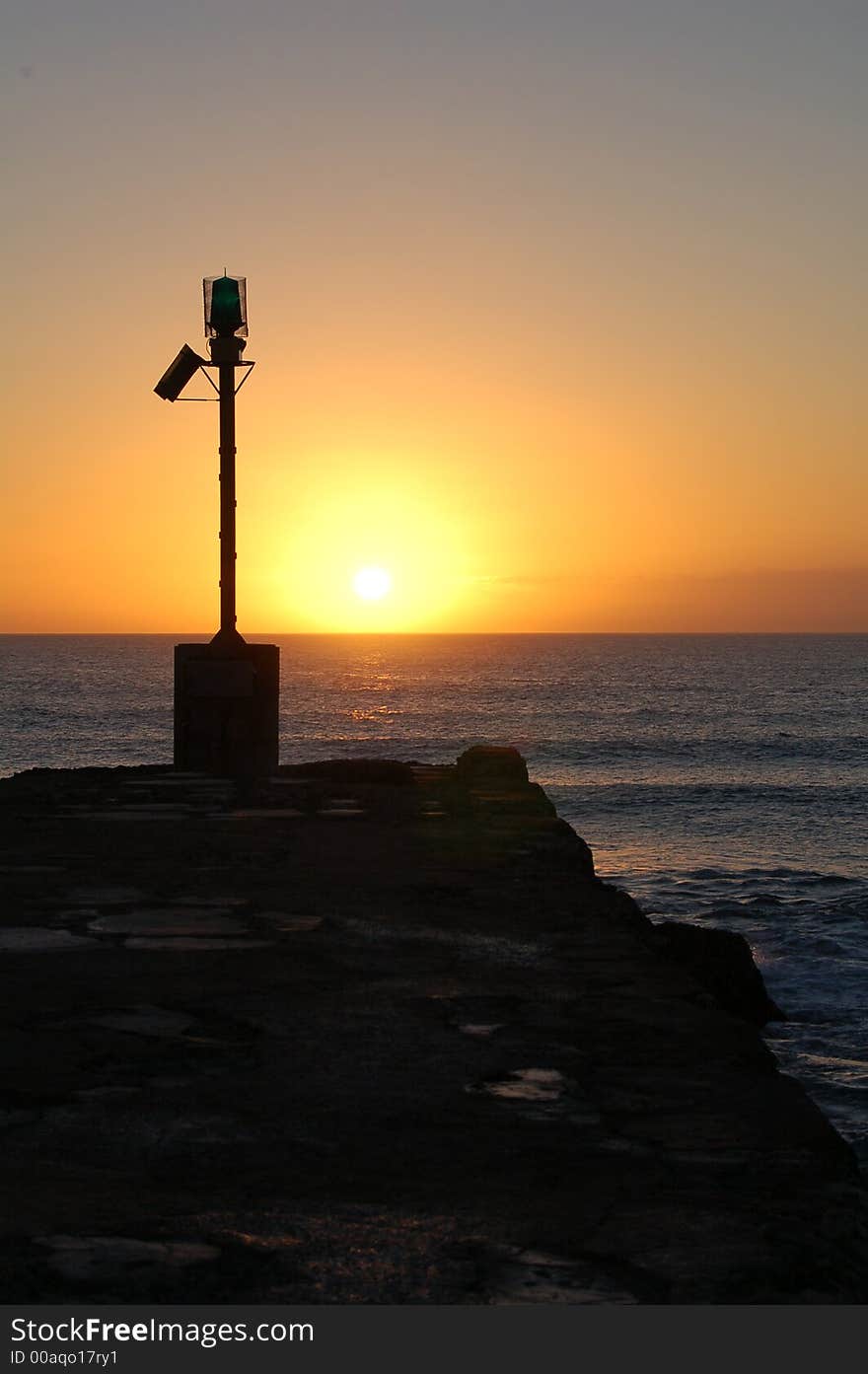 Sun coming up over the Indian Ocean in the East on the Eastern Cape coastline of South Africa from the Port Alfred, East Bank pier. Sun coming up over the Indian Ocean in the East on the Eastern Cape coastline of South Africa from the Port Alfred, East Bank pier