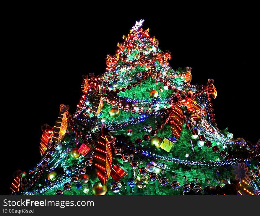 Pine-tree decorated with lights & garlands in holy night. Pine-tree decorated with lights & garlands in holy night