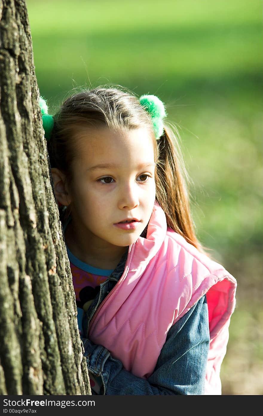 Portrait of little pretty girl in the park