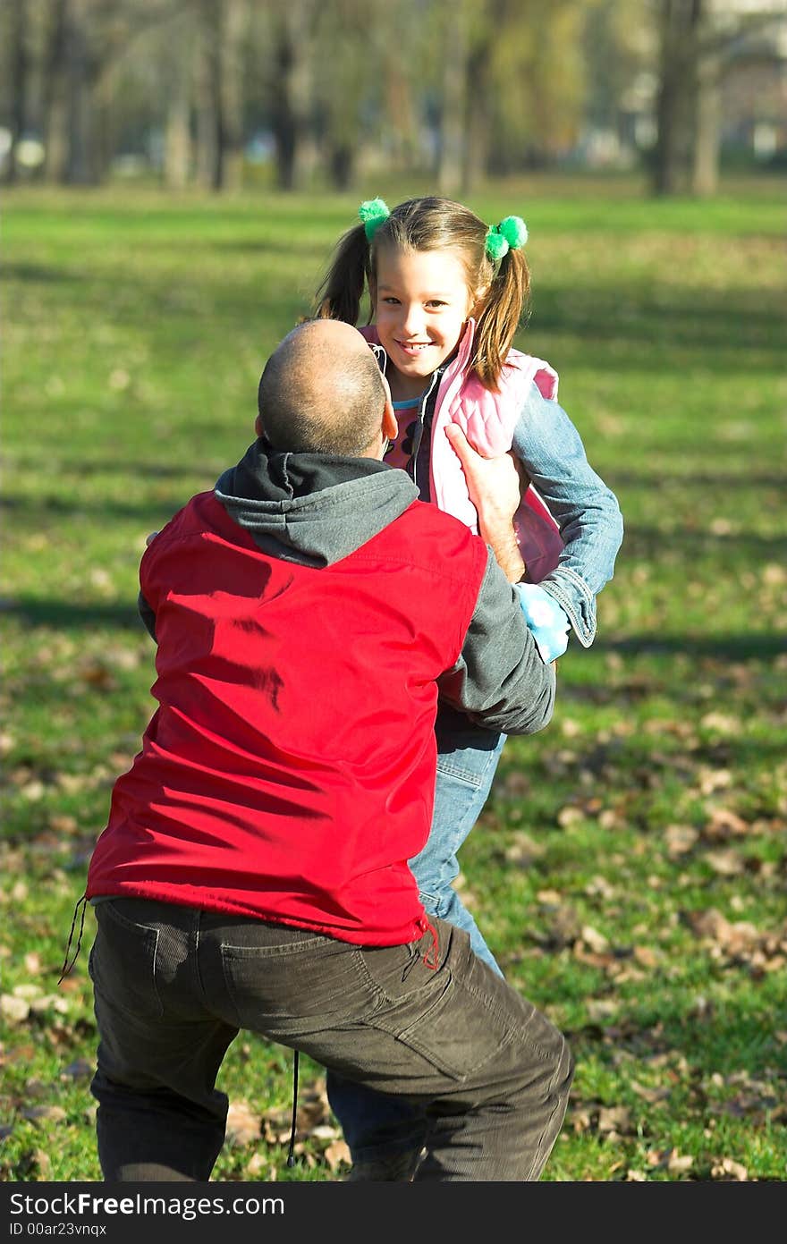 Little pretty child happy running to father in the park