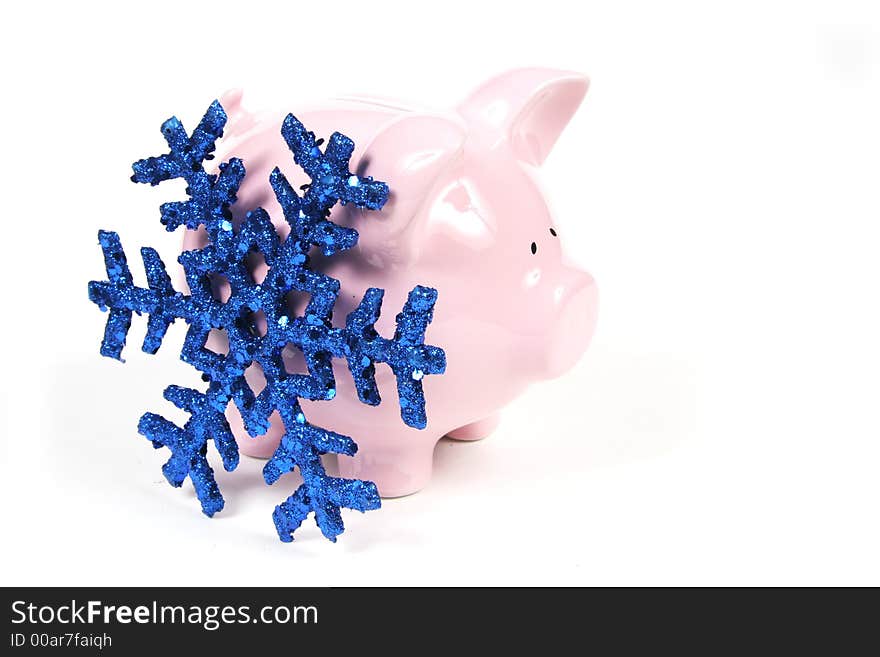 Pink Piggy Bank on isoalted on white background with blue snowflake. Pink Piggy Bank on isoalted on white background with blue snowflake