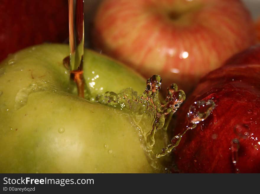 Large, ripe apples under a jet of water. Large, ripe apples under a jet of water.